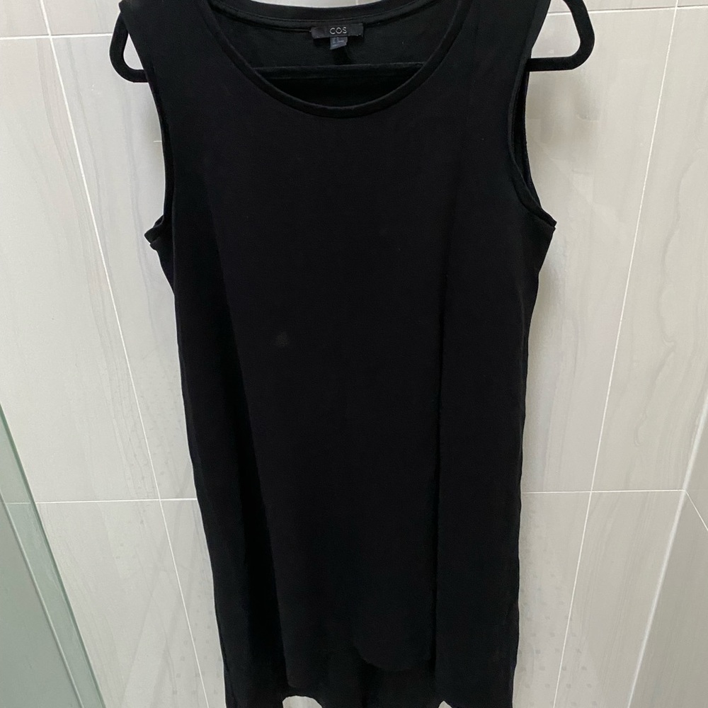 Black COS sleeveless dress with asymmetrical hem.